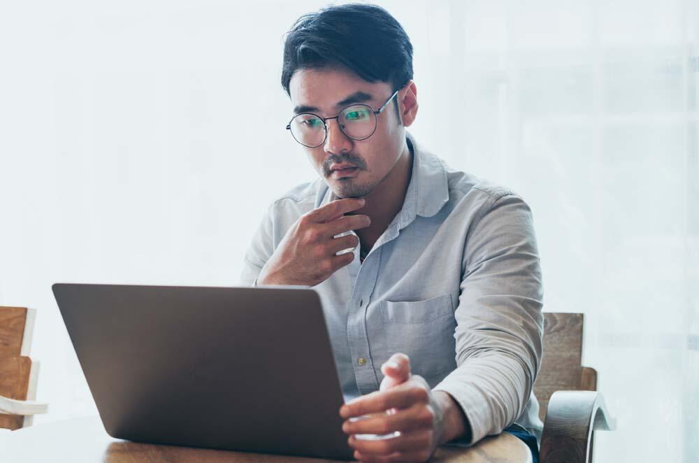 Man looking intently at laptop