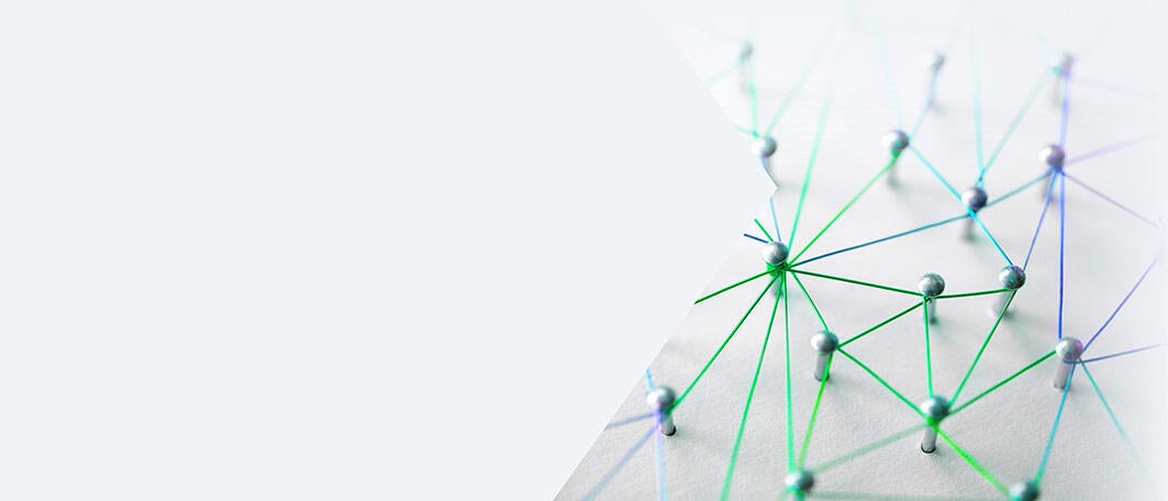 Web of blue, purple, and green wires on a white background